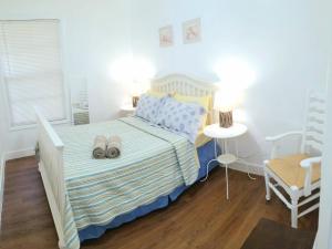 a bedroom with a bed with two slippers on it at La Villa Azul - A Beachy Stay in Miami in Miami
