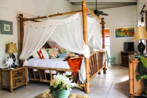 a bedroom with a bed with a canopy at The Mafolie Hotel in Mafolie