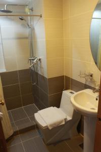 a bathroom with a shower and a toilet and a sink at Prince Plaza II Condotel in Manila