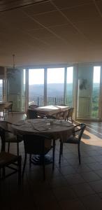 a dining room with tables and chairs and windows at Mamma Teresa in Sestola