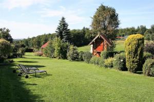 a park bench sitting in the middle of a field at Ferienhaus Grimm in Friedrichsbrunn