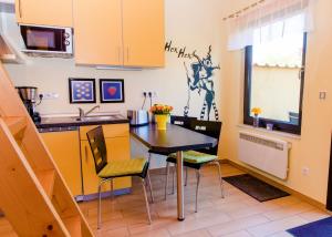 a kitchen with a table and chairs and a sink at Ferienhaus Hexenschlummer - Schlafzimmer und romantischer Schlafboden in Thale