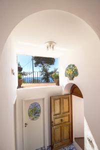 a hallway with a door and a window at La Cuchina in Capri