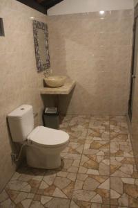 a bathroom with a toilet and a sink at Bukit keker cottage in Nusa Penida