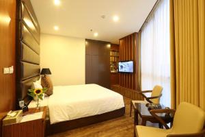 a hotel room with a bed and a desk and a chair at Au Viet Hotel in Hanoi