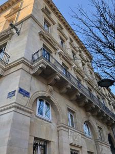 a building with a balcony on the side of it at Les Folies de Chauvin in Bordeaux