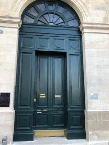 a large black door on the side of a building at Les Folies de Chauvin in Bordeaux
