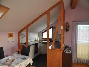a small kitchen with a wooden door in a room at Ferienwohnung Lore in Weiler-Simmerberg