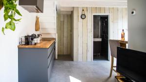 a kitchen with a sink and a counter top at B&B Joeys place in Egmond aan Zee