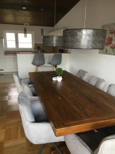 a dining room with a wooden table and chairs at Villa Alpenblick in Füssen