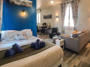 a bedroom with a large bed and a living room at Cosy'Appart - COEUR DE SEINE in Rouen