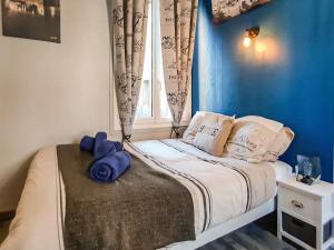 Un dormitorio con una cama con paredes azules y una ventana en Cosy'Appart - COEUR DE SEINE, en Rouen