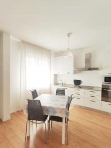 a kitchen and dining room with a table and chairs at Maredena in Lido di Jesolo