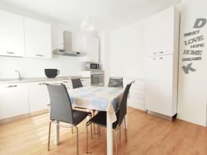 a kitchen and dining room with a table and chairs at Maredena in Lido di Jesolo