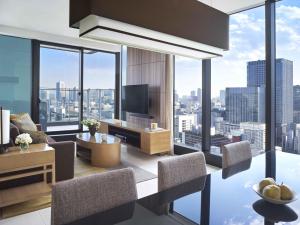a living room with a view of a city at Oakwood Premier Tokyo in Tokyo