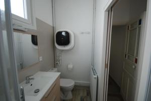 a white bathroom with a toilet and a sink at La réserve à bonheurs in Les Sables-dʼOlonne +15 photos
