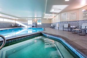 a pool in a hotel room with a swimming pool at Holiday Inn Express & Suites Colorado Springs Central by IHG in Colorado Springs