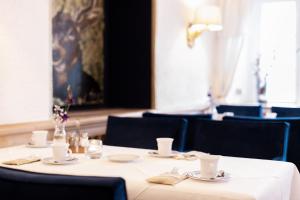 a dining table with a white tablecloth and chairs at Landgasthof Karner in Frasdorf