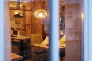 a dining room with a table and a light fixture at Hotel Ahornhof in Lindberg +40 photos