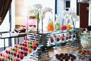 a display of different colored drinks in vases at Arctic Light Hotel in Rovaniemi