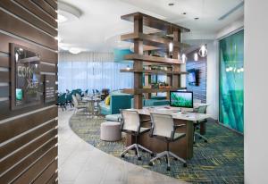 a restaurant with a table with chairs and a laptop at EVEN Hotel Miami - Airport by IHG in Miami