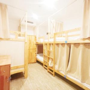 a room with two bunk beds and a window at Shanghai Blue Mountain Bund Youth Hostel in Shanghai