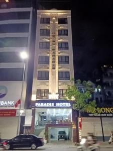 a building with a car parked in front of it at Paradis Hotel in Ha Long