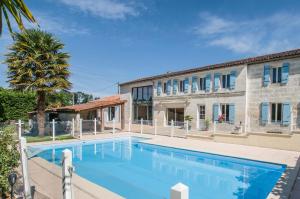 a large swimming pool in front of a building at Les Cuves - Saintes in Chaniers