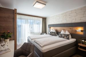 Letto o letti in una camera di Hotel Baumgarten & Chalet Baumgarten