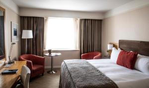 Uma cama ou camas num quarto em The River Lee Hotel a member of The Doyle Collection