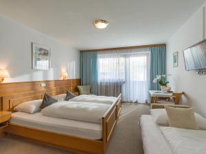 Letto o letti in una camera di Hotel Baumgarten & Chalet Baumgarten