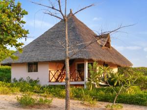 a thatch roofed house with a thatched roof at 2 bedrooms house at Cap Skirring 50 m away from the beach with sea view furnished terrace and wifi in Kabrousse