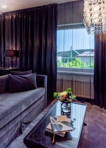 a living room with a couch and a glass table at Arctic Light Hotel in Rovaniemi