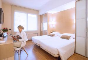 Postel nebo postele na pokoji v ubytování Aparthotel Silver