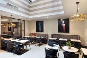 a dining room with tables and chairs at Best Western Plus Hôtel Massena Nice in Nice