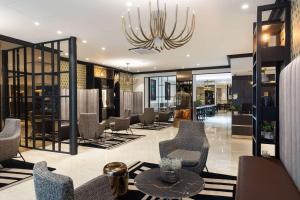 a lobby with chairs and a chandelier at Best Western Plus Hôtel Massena Nice in Nice
