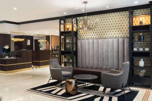 a lobby with a couch and chairs and a table at Best Western Plus Hôtel Massena Nice in Nice