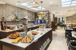 a buffet line with food on display in a restaurant at Best Western Plus Hôtel Massena Nice in Nice