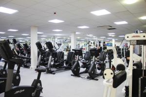 a gym with a lot of treadmills and machines at Windmill Village Hotel, Golf Club & Spa, BW Signature Collection in Coventry