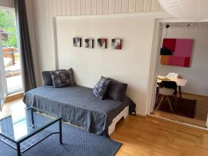 a bedroom with a bed and a chair in a room at Apartment am Wildbach - Radeln, Wandern, Natur, Urlaub mit Hund in Fischbachau