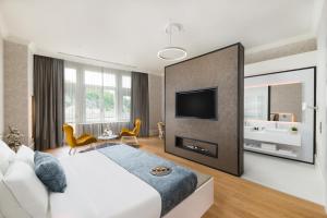 a bedroom with a large bed and a tv in it at Hotel Vision Budapest by Continental Group in Budapest