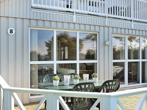 a patio with a table and chairs on a house at Three-Bedroom Holiday home in Gelting 7 in Gelting