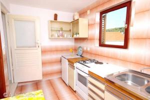 a small kitchen with a sink and a stove at Villa Marga in Jelsa