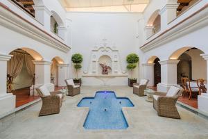 a lobby with a blue pool in the middle of a room at Palacio Borghese Hotel Boutique - Adults Only in Oaxaca City