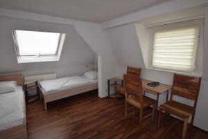 a small room with a bed and a table and chairs at Apartment Nürtingen in Nürtingen