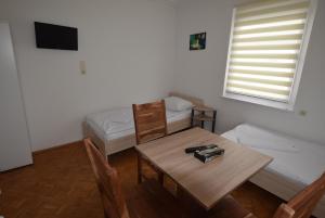 a room with a table and a bed and a table and chairs at Apartment Nürtingen in Nürtingen