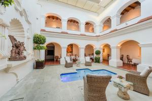 a lobby with a pool in the middle of a building at Palacio Borghese in Oaxaca City