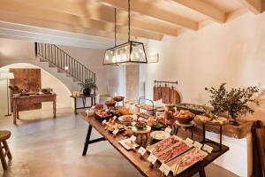 a table with many different types of food on it at Finca Serena Mallorca, Small Luxury Hotels in Montuiri