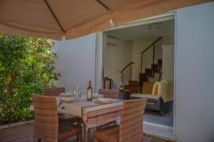 a table with a bottle of wine and chairs on a patio at Belvillas in Montauroux