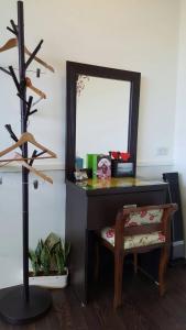 a desk with a mirror and a chair in a room at Qinbianlu B&B in Jiufen